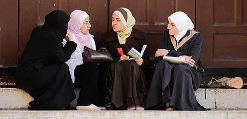 Group of young Muslim women talking in Omayad mosque courtyard , Damascus , Syria