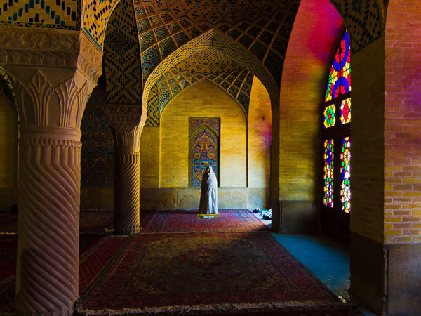 Woman in chador praying in Vakin mosque, Shiraz